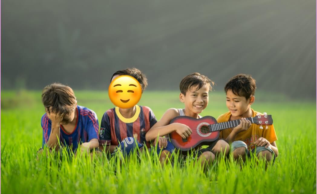 A picture of 4 boys with a sticker on one boy's face